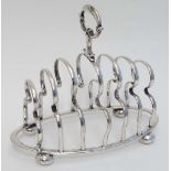 A silver plate 7 bar toast rack on ovoid base with four squat bun feet  approx 6" high x 7" long