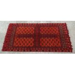 Rug / Carpet : A Turkoman Bokhara rug with cross design to centre and having four fields.   With