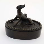 A Regency patinated bronze oval desk weight in the form of a sejant dog. 3 1/4" wide x 2 3/4"