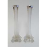 A pair of glass bud vases with silver collars hallmarked London 1925 maker Henry Hobson & Sons. 8"