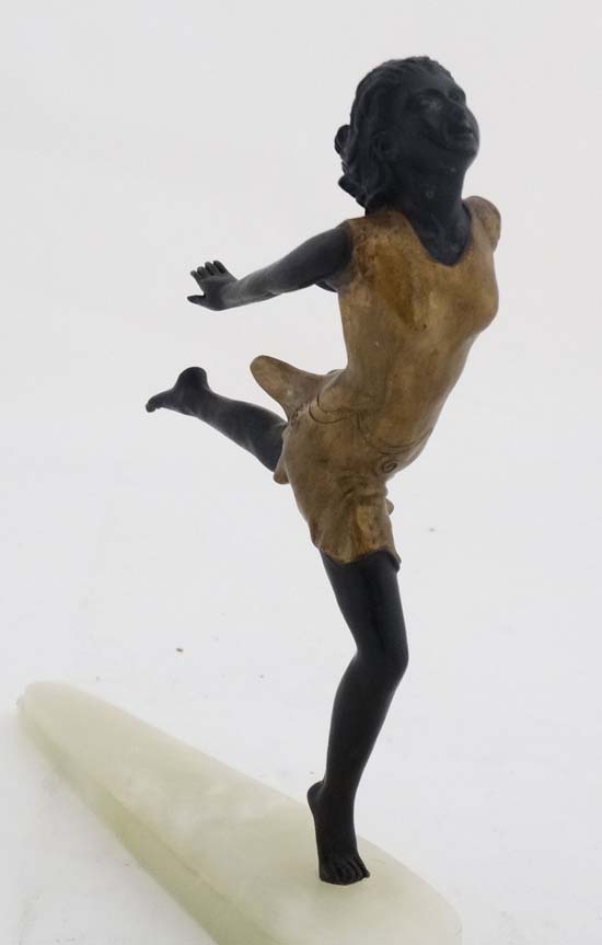 A cast and patinted bronze sculpture in the Art Deco style depicting a young girl upon an