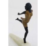 A cast and patinted bronze sculpture in the Art Deco style depicting a young girl upon an