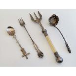 A silver plate pickle fork together with a silver plate bread fork, white metal teaspoon and a small