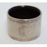 An Art Deco silver napkin ring with engine turned decoration and Bakelite lining. Hallmarked