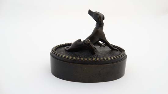 A Regency patinated bronze oval desk weight in the form of a sejant dog. 3 1/4" wide x 2 3/4" - Image 4 of 6