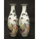 A pair of early 20thC Oriental famille rose vases . Decorated with female figures in a garden