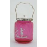 A Cranberry glass biscuit barrel with enamel Mary Gregory style decoration depicting a child with