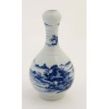 A Chinese blue and white garlic head bottle vase, decorated with a mountainous landscape having
