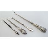 Button hooks : 3 various silver handled button hooks together with a silver plate example. The