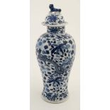 A late 19thC Chinese blue and white lidded vase , decorated with 4 clawed dragons on a floral and