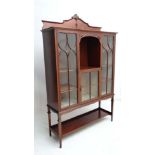 A fine later Victorian glazed front display case with open section over a glazed door section