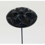 Hat Pin : A hat pin surmounted by a carved Whitby jet roundel.  The whole 10 1/2 " long
