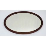 An Edwardian mahogany inlaid oval bevelled wall mirror 22" high  x 32" wide  CONDITION: Please