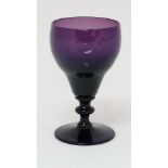 A 19thC amethyst glass wine glass. Approx 6" tall.  CONDITION: Please Note -  we do not make