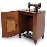 Frister and Rossmann : An early 20thC  walnut cased treadle sewing machine with Egyptian motiffs