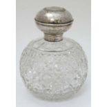 A cut glass perfume bottle of spherical form with silver collar and lid. Hallmarked Birmingham