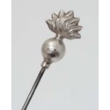 Hat Pin : A hat pin surmounted by a silver flaming grenade and marked C.H Sterling. Probably by
