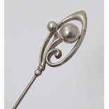 Hat Pin : A hat pin surmounted by white metal scrolling detail and marked C.H Probably by Charles