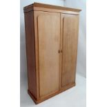 A Victorian pine double wardrobe opening to reveal hat shelf, hanging section, three graduated