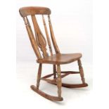A 19thC elm seated rocking chair with high back and unusual pierced bottle shaped back splat 35 1/2"