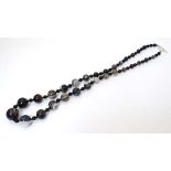 A necklace of graduated agate beads. Approx 24" long CONDITION: Please Note -  we do not make