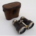 A pair of early 20thC chrome plated brass and leather covered binoculars with leather case