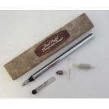 A cased Dual model electronic pencil, opening to reveal chromed components etc. The box 8 5/8" long