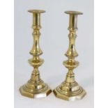 A pair of Victorian brass ejector candlesticks with octagonal shaped bases. Standing 10 1/2''  high.