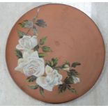 An early 20th C Watcombe Torquay charger. Decorated with white roses on a terracotta ground.