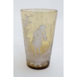 An amber glass beaker with Mary Gregory style decoration and engraved ' Kathleen ' together with a