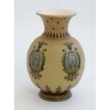 A 20thC Mettlach German Stoneware ovoid vase with flared rim, having relief decoration on a cream