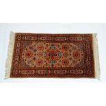 Rug / Carpet : a 20 th C Turkish woollen rug with geometric corner pieces, decorative central