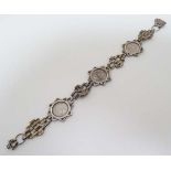 A silver bracelet set with 3 George V threepenny coins dated 1916,1917,1918. Approx 7 ½” long