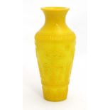 A 20thC Chinese Peking yellow glass vase decorated with figures in a landscape and marked with