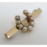 A gilt metal bar brooch with central horseshoe set with  graduated pearls  1 ¼” wide CONDITION: