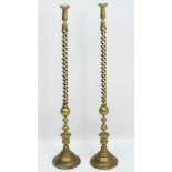 A pair of exceptionally large brass double open twist candlesticks on turned circular bases. 46 1/2"