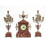 Rose Marble French Mantle clock and Garnitures :  a Marble cased and urn mounted clock with a pair