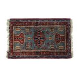 Rug  / Carpet : a Caucasian woollen prayer rug with light blue ground, geometric medallion, two