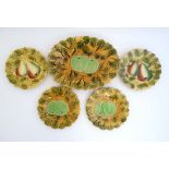 A set of 4 1920s Sarreguemines majolica plates decorated with fruit , together with a matching dish,