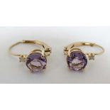 A pair of yellow metal drop earrings set with amethysts and white stones.  CONDITION: Please Note -