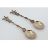 A pair of Dutch silver teaspoons the handles formed as windmills with articulated sails. 5" long