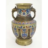 Cloisonné : An Oriental brass vase of baluster form with Cloisonne decoration and qilin formed