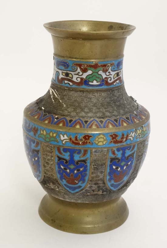 Cloisonné : An Japanese brass vase of baluster form with Cloisonne mask and shield decoration to