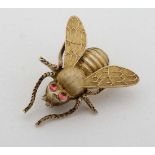 A gilt brooch formed as a bee with red stone eyes. Approx ¾” long  CONDITION: Please Note -  we do