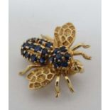 A 14k gold brooch formed as a bee and set with semi-precious blue stones. Approx 3 ¾” long