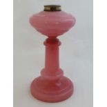 Oil lamp column : a Victorian pink glass column with integral reservoir .11" high    
 CONDITION: