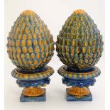 A pair of 19thC majolica style artichoke finials on pedestal bases, decorated in shades of blue,