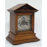 Jurgans clock : an Oak Architectural cased  8 day clock, striking in a coiled gong, striking on