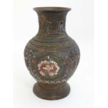 Cloisonné : A Japanese brass vase of baluster form with Cloisonne decoration depicting flowers to