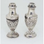 A pair of Victorian silver pepperettes with embossed decoration. Hallmarked Birmingham 1896 maker